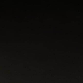 Dark gradient texture, nearly black, with a smooth woven or subtly textured material and uniform composition throughout the frame.